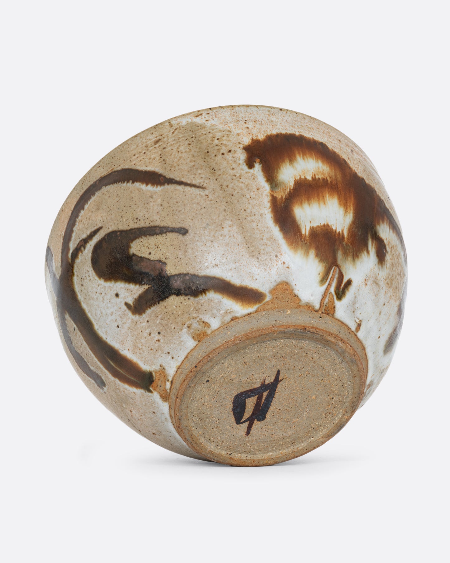 A brown bowl with brown brushstrokes all over. Shown on its side from the bottom.