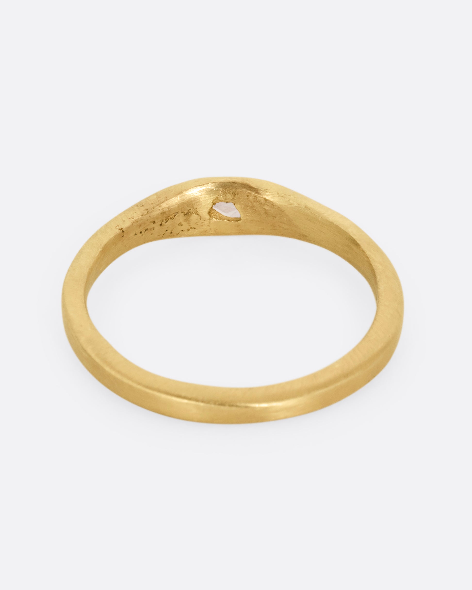 A yellow gold ring with a rose cut diamond. Shown from the back.