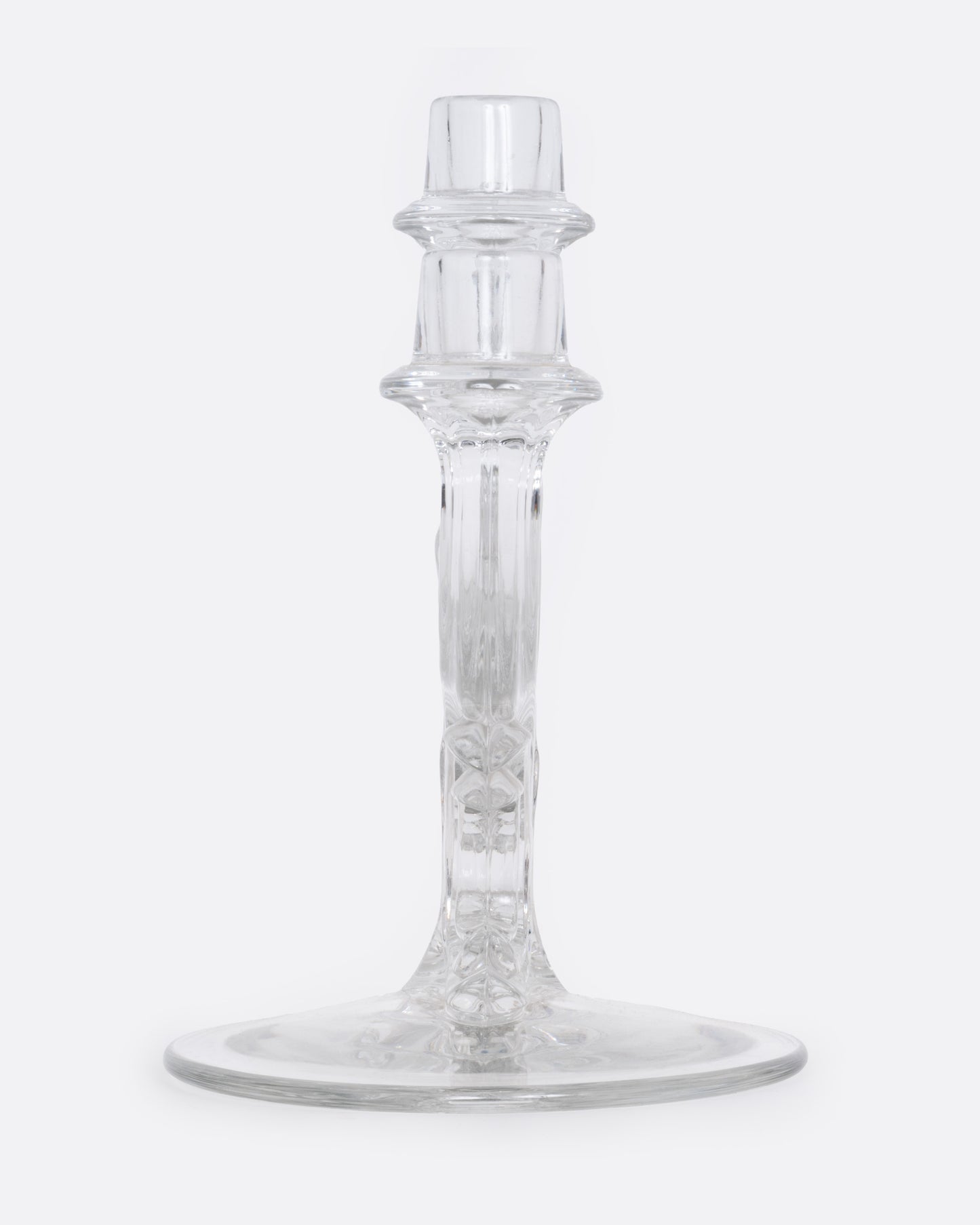 A clear glass candelabra with three holders, shown from the side.