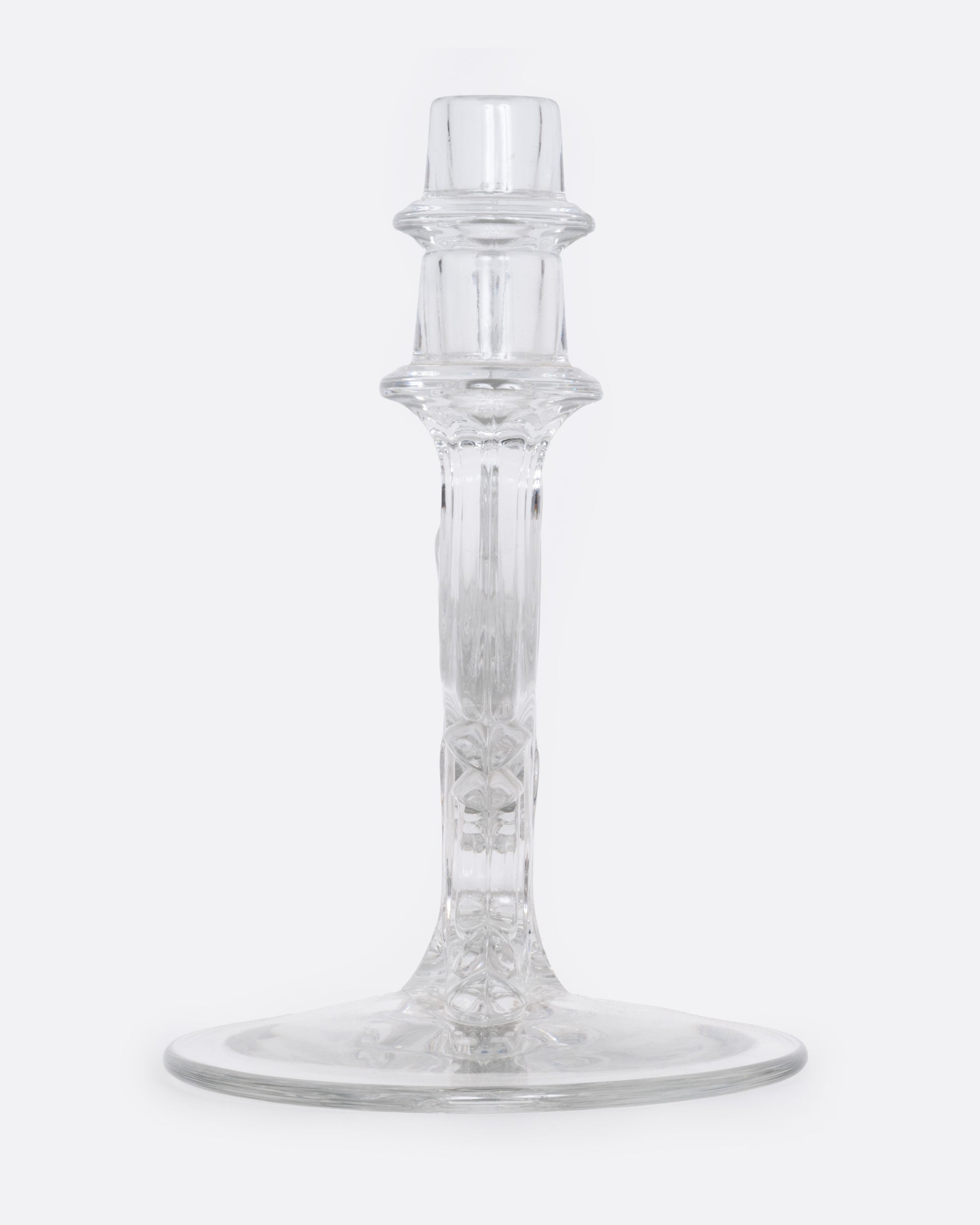 A clear glass candelabra with three holders, shown from the side.