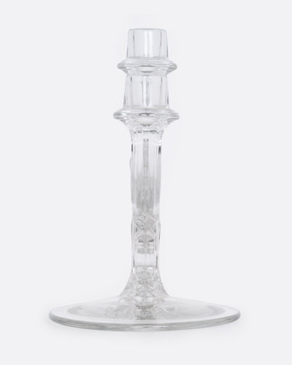 A clear glass candelabra with three holders, shown from the side.