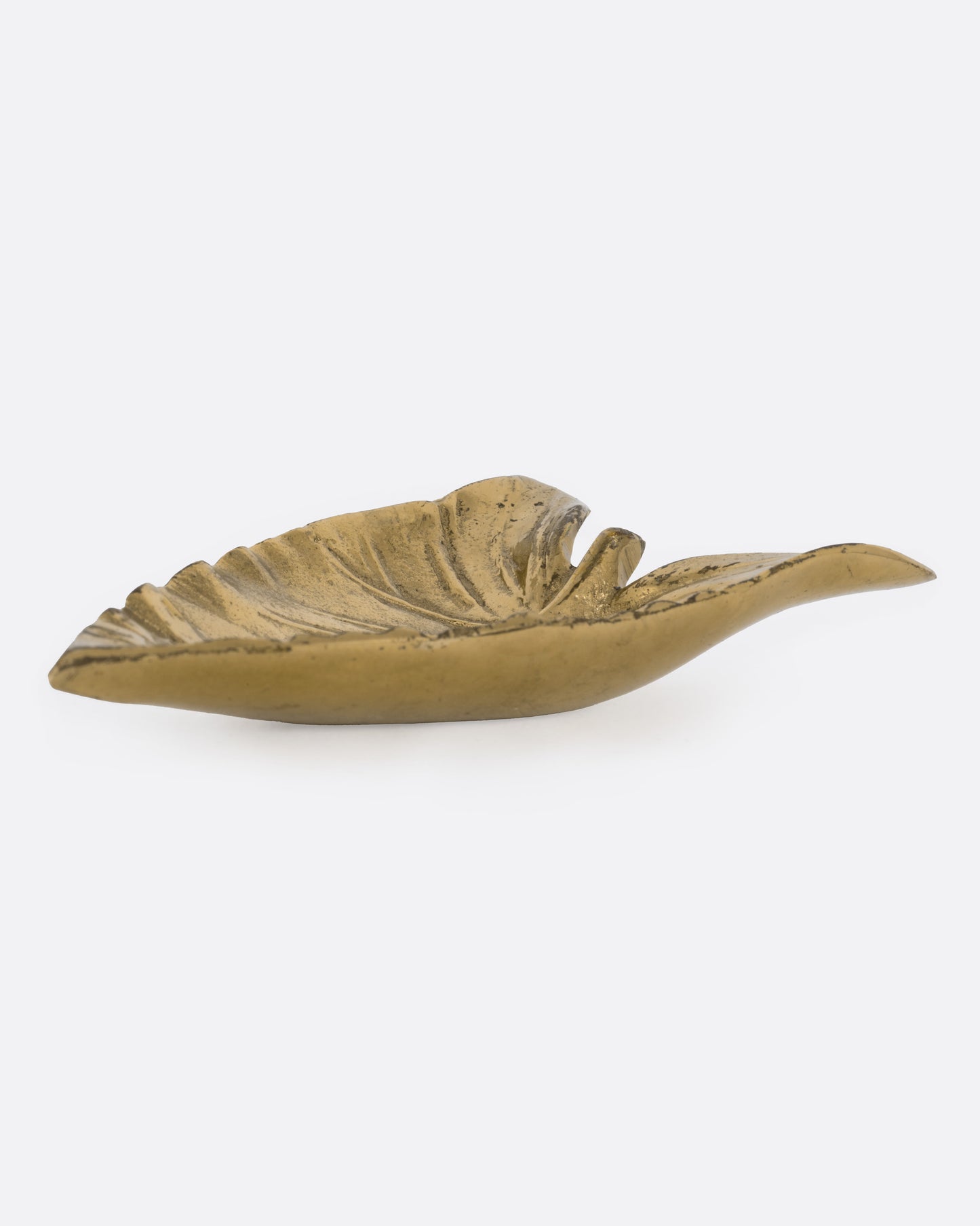 A brass calla lily leaf shaped dish, shown from the side.