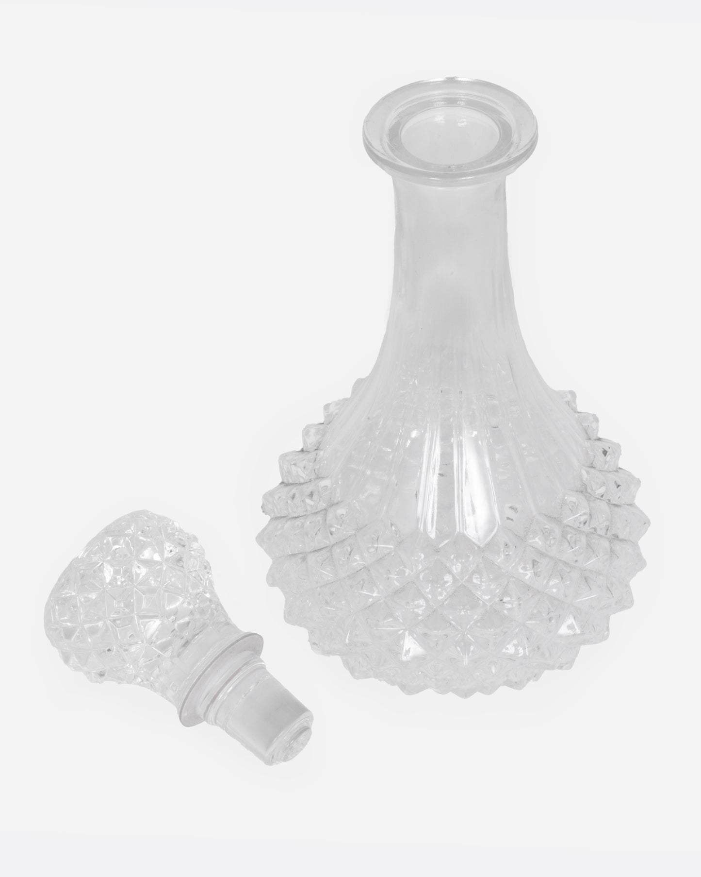 A crystal cut glass decanter, shown from the top open.