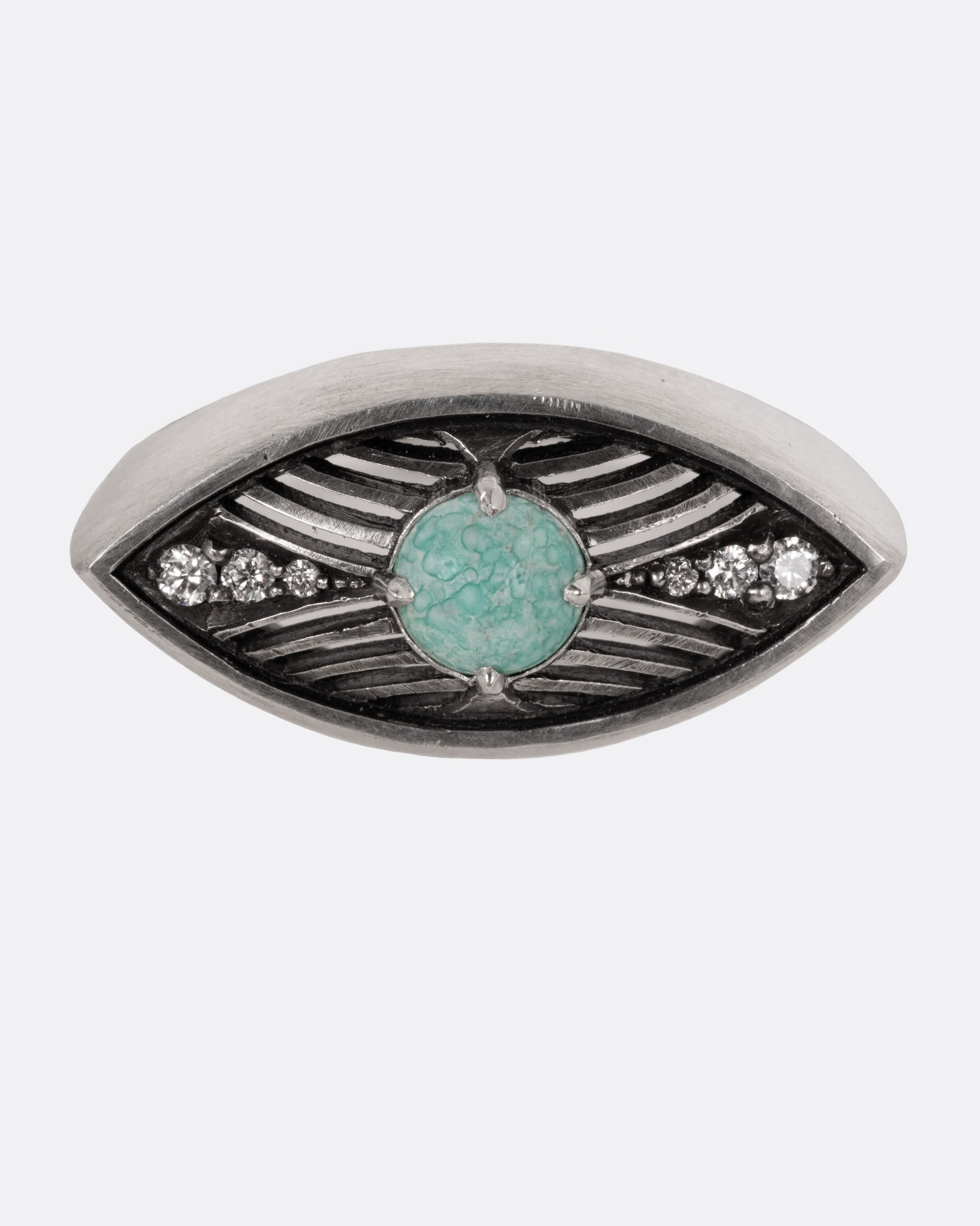 A silver eye shaped ring with a marbled Mexican turquoise cabochon and diamond details, shown from the front.