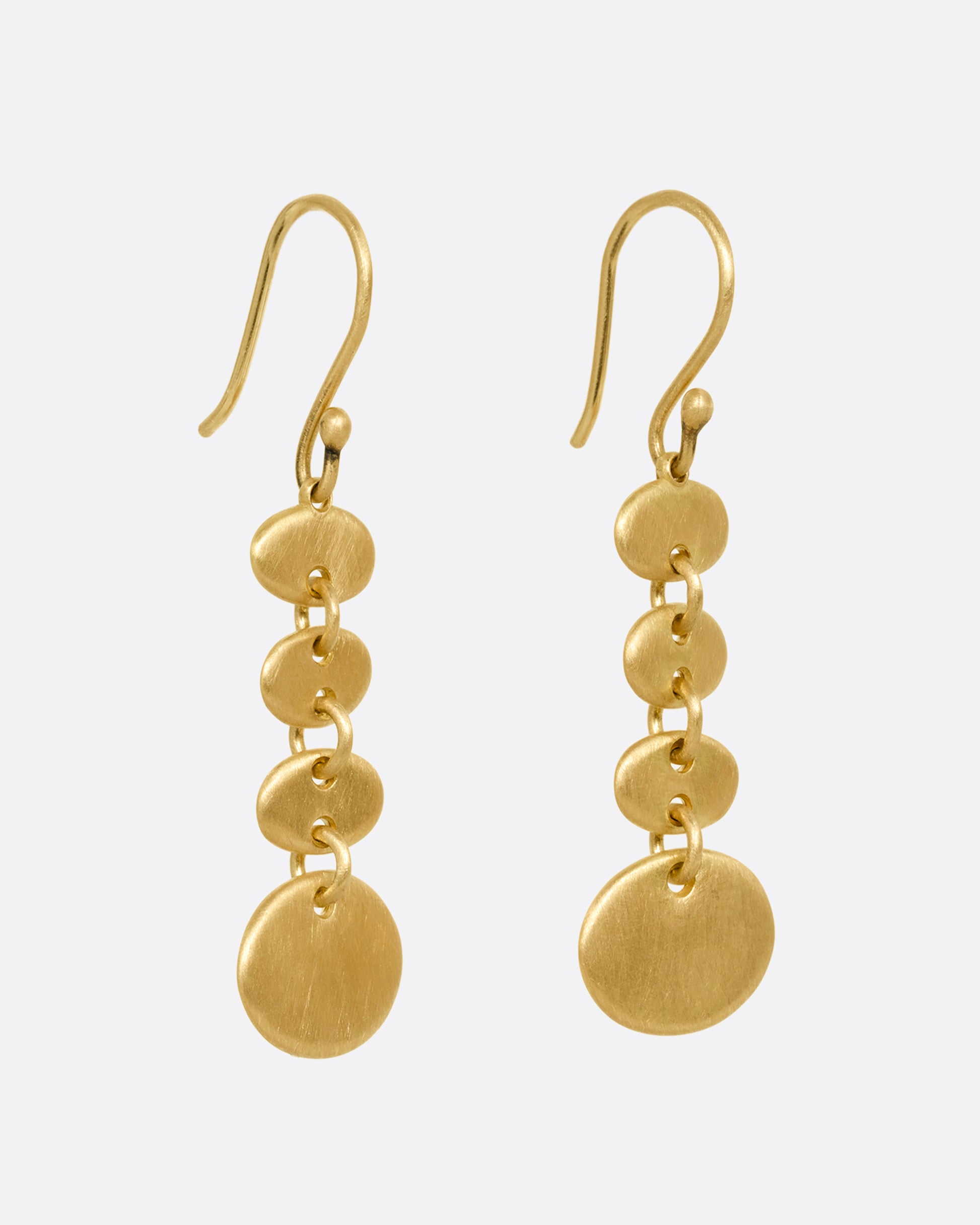 A yellow gold pair of earrings with linked graduated ovals. Shown from the side.