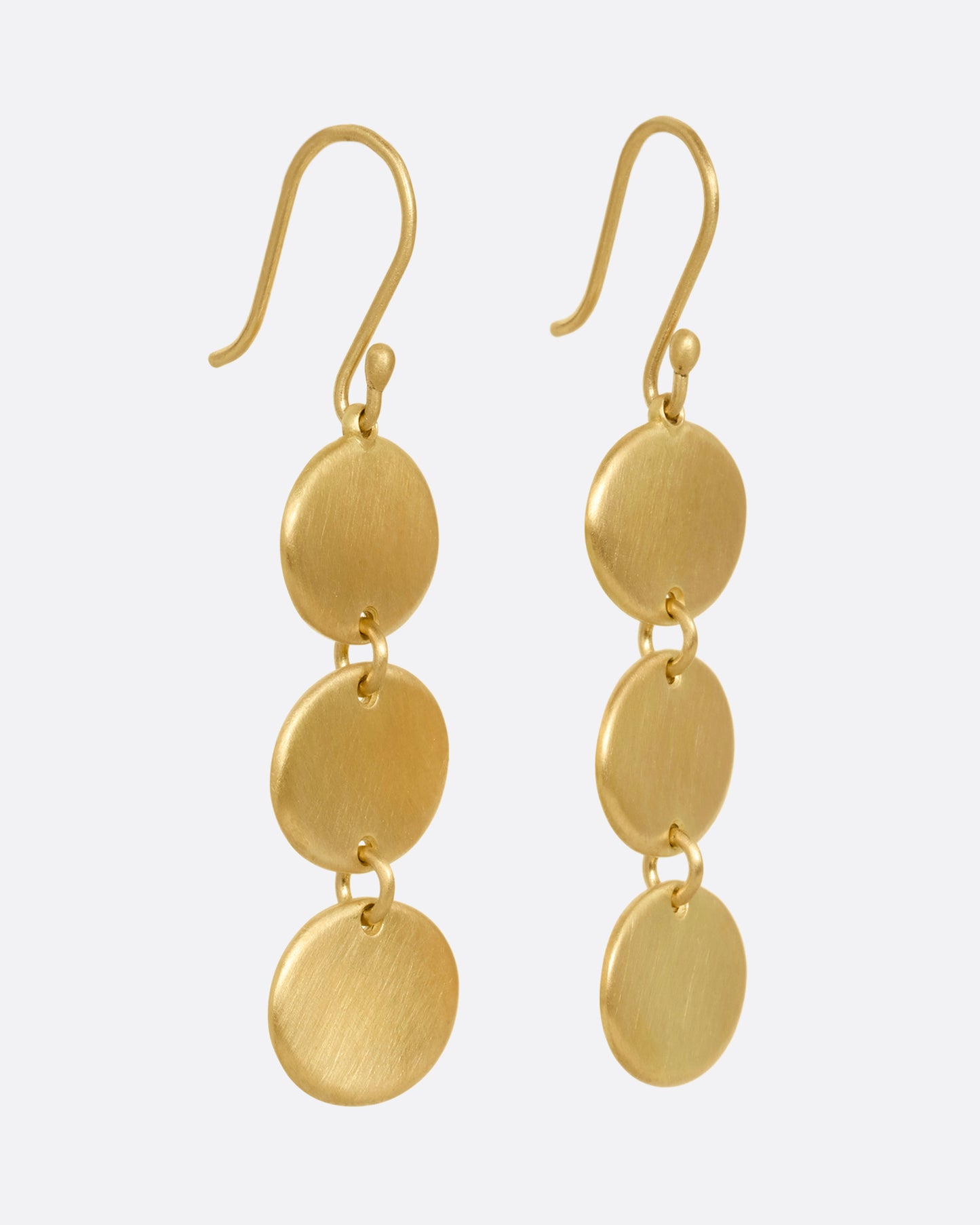 A pair of yellow gold dangle earrings with three linked ovals. Shown from the side.