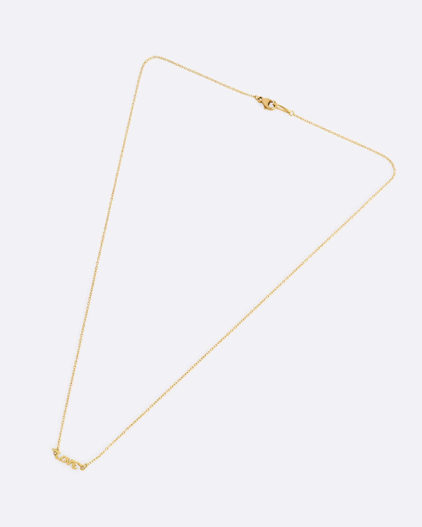 A yellow gold cable chain necklace with a 'LOVE' charm at the center. Shown closed lying flat from the front.