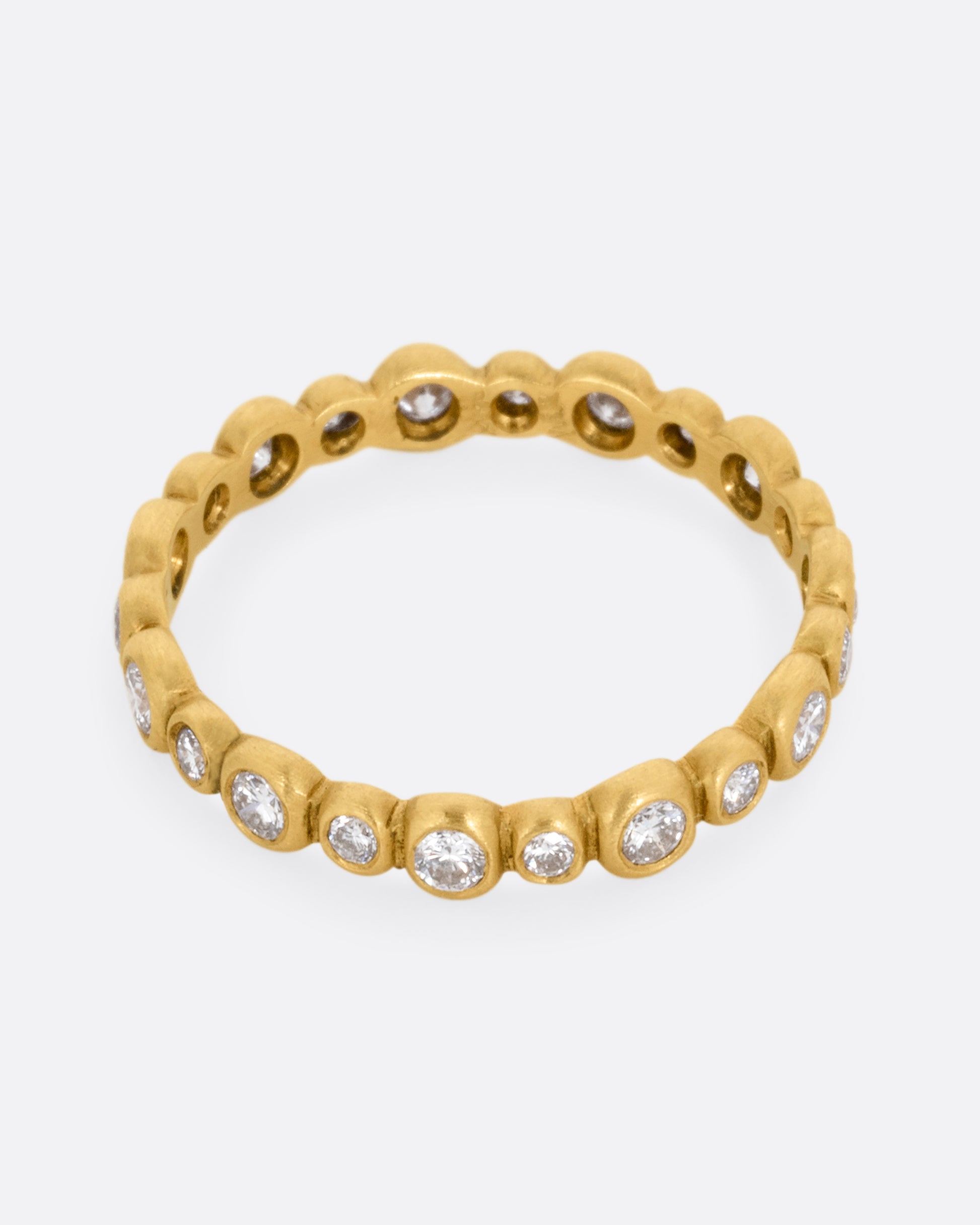  A yellow gold ring with a bubbly pattern of diamonds. Shown from the front.