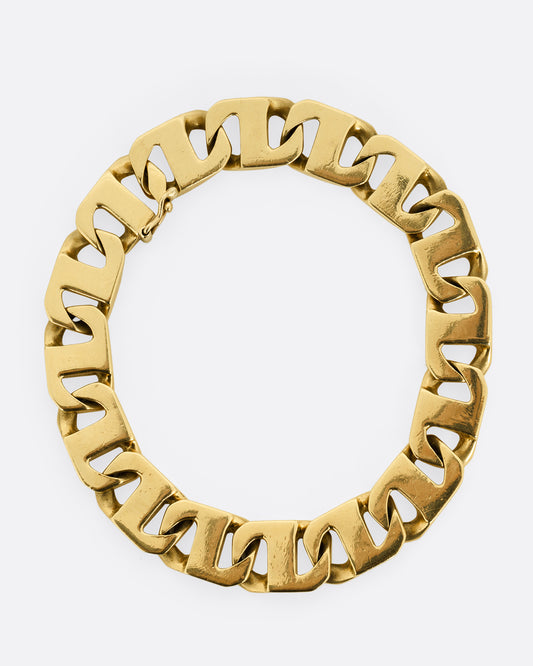 A yellow gold anchor link bracelet. Shown lying flat from the top.