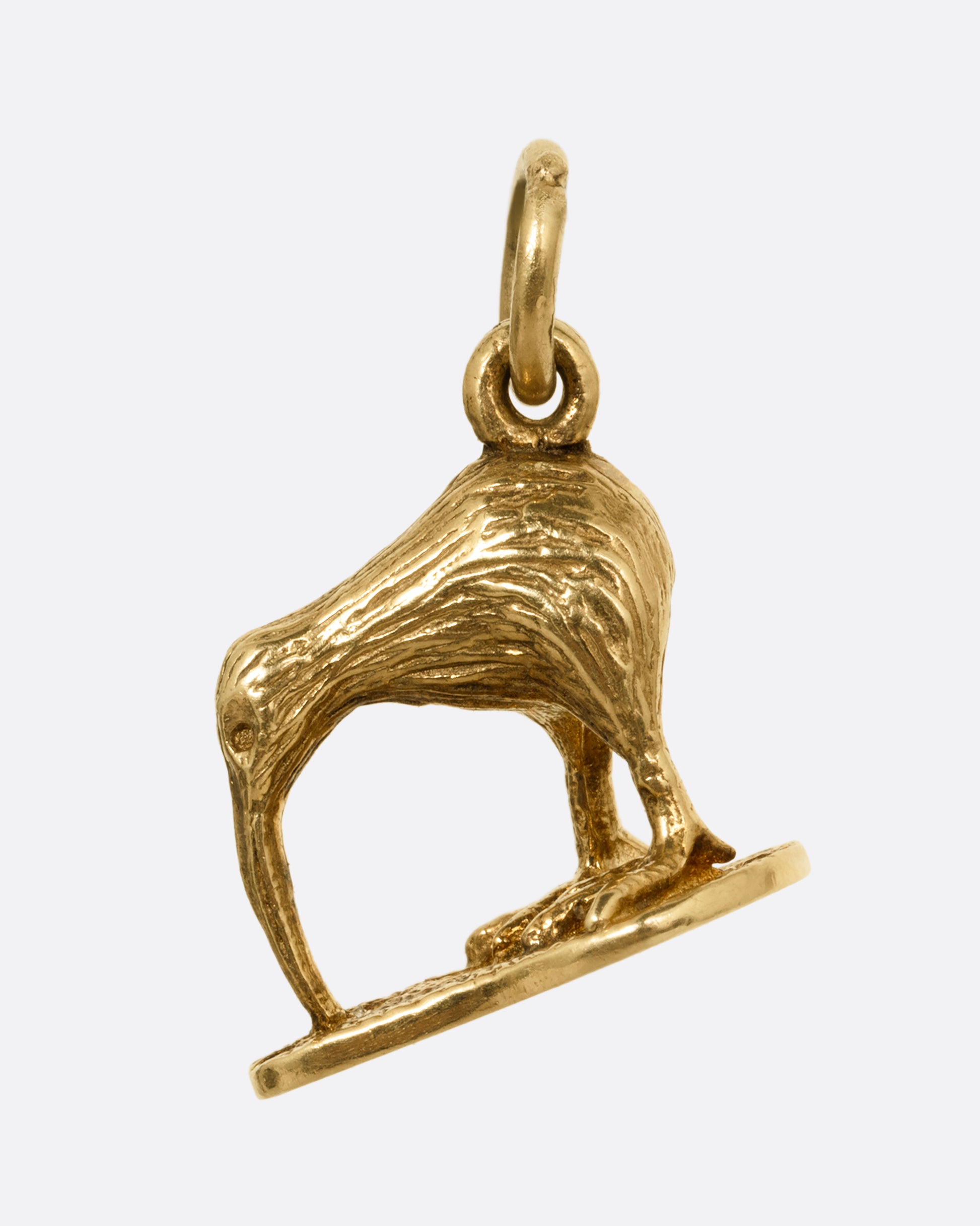 A yellow gold kiwi bird pendant. Shown from the back.