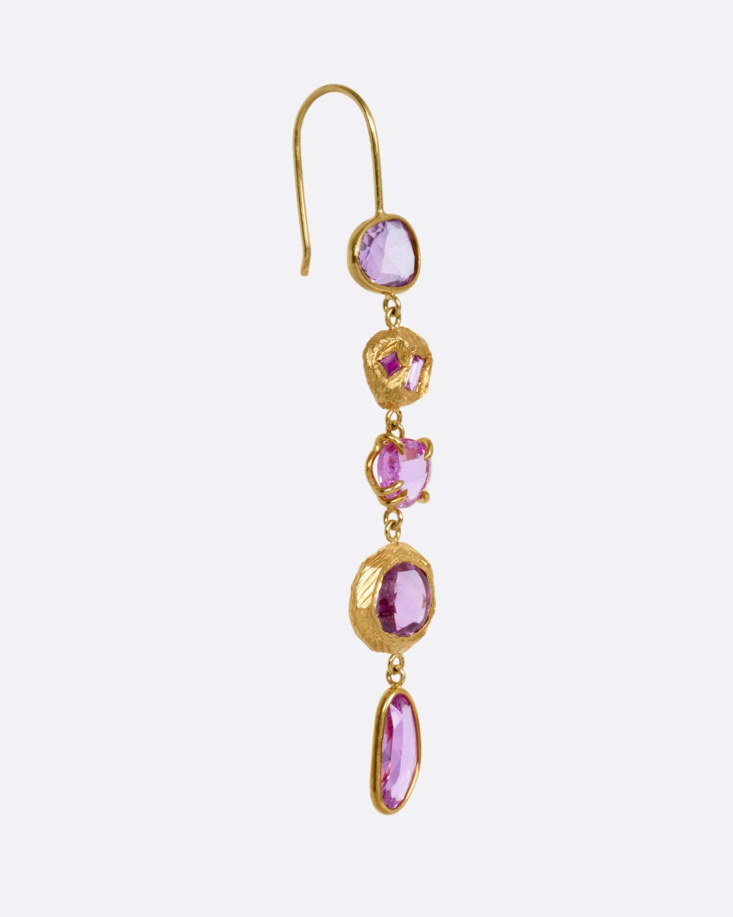 A yellow gold drop earring with pink sapphires and ruby and diamond accents, shown from the side.