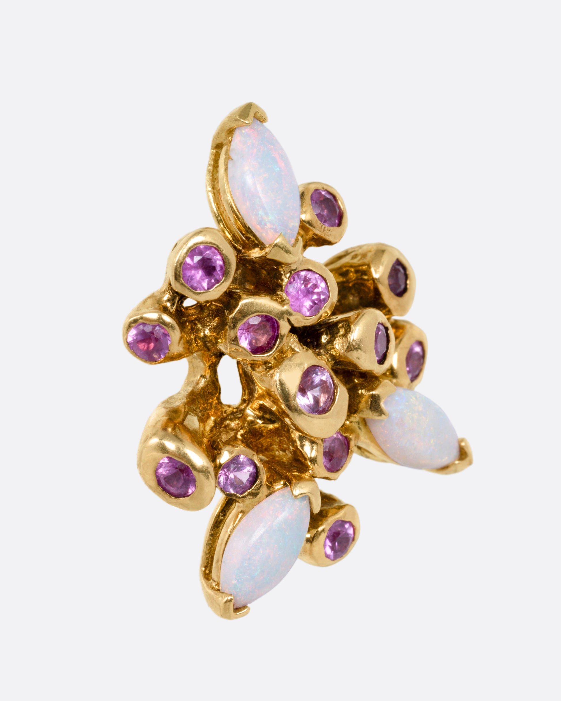 A yellow gold starburst stud earring with pink sapphires and opals, shown from the side.