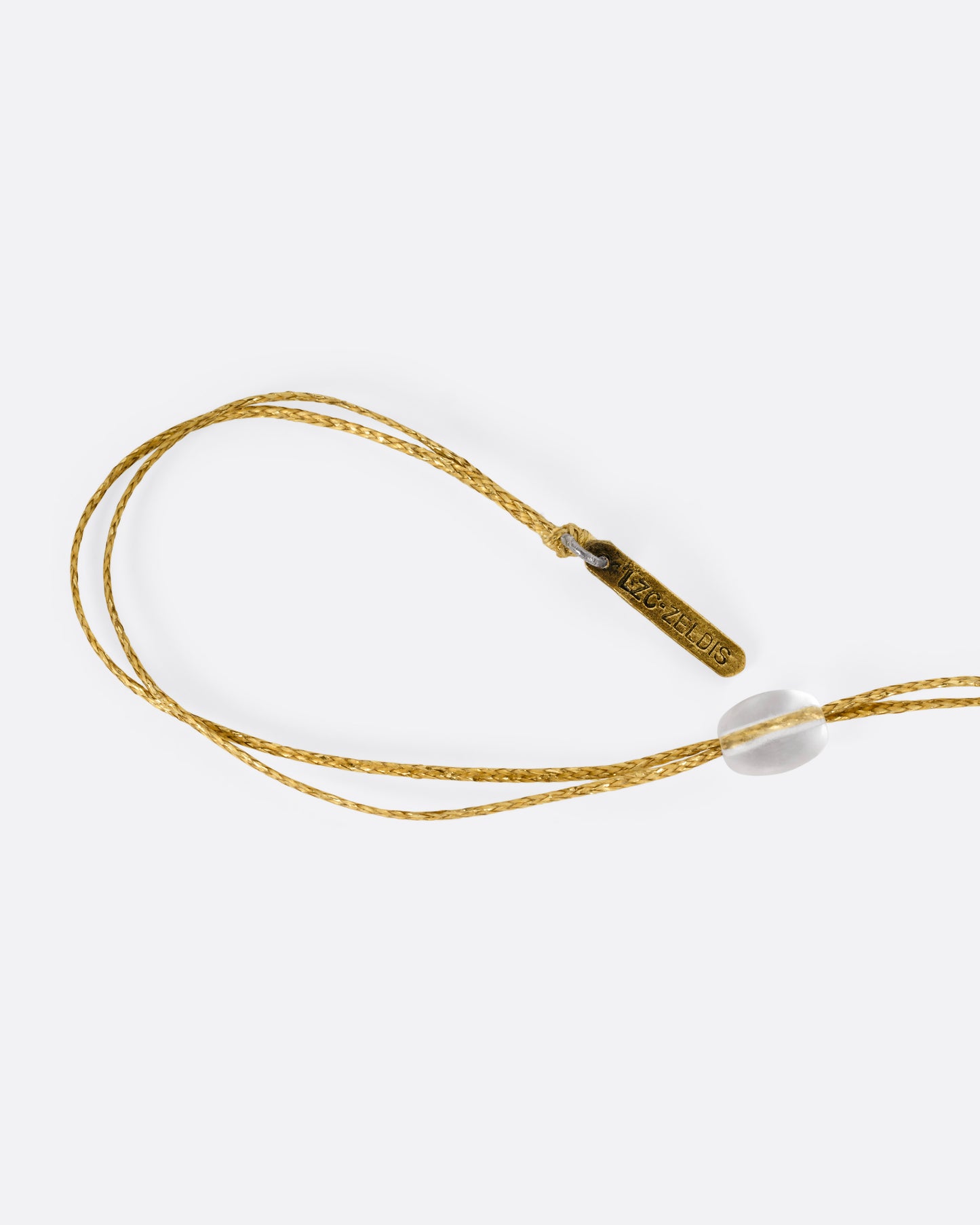A close up of the cord and adjustable closure of a necklace.