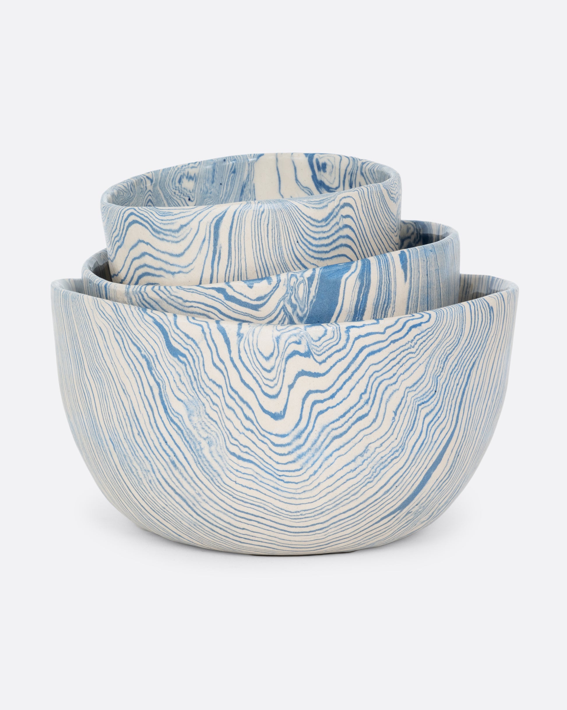 These small batch ceramic bowls look plucked straight from the ocean, with flowing hues of blue and white. They're made with a traditional Japanese Nerikomi technique that creates an intricate, marbled design by layering and compressing clay. Available in small, medium, and large sizes.