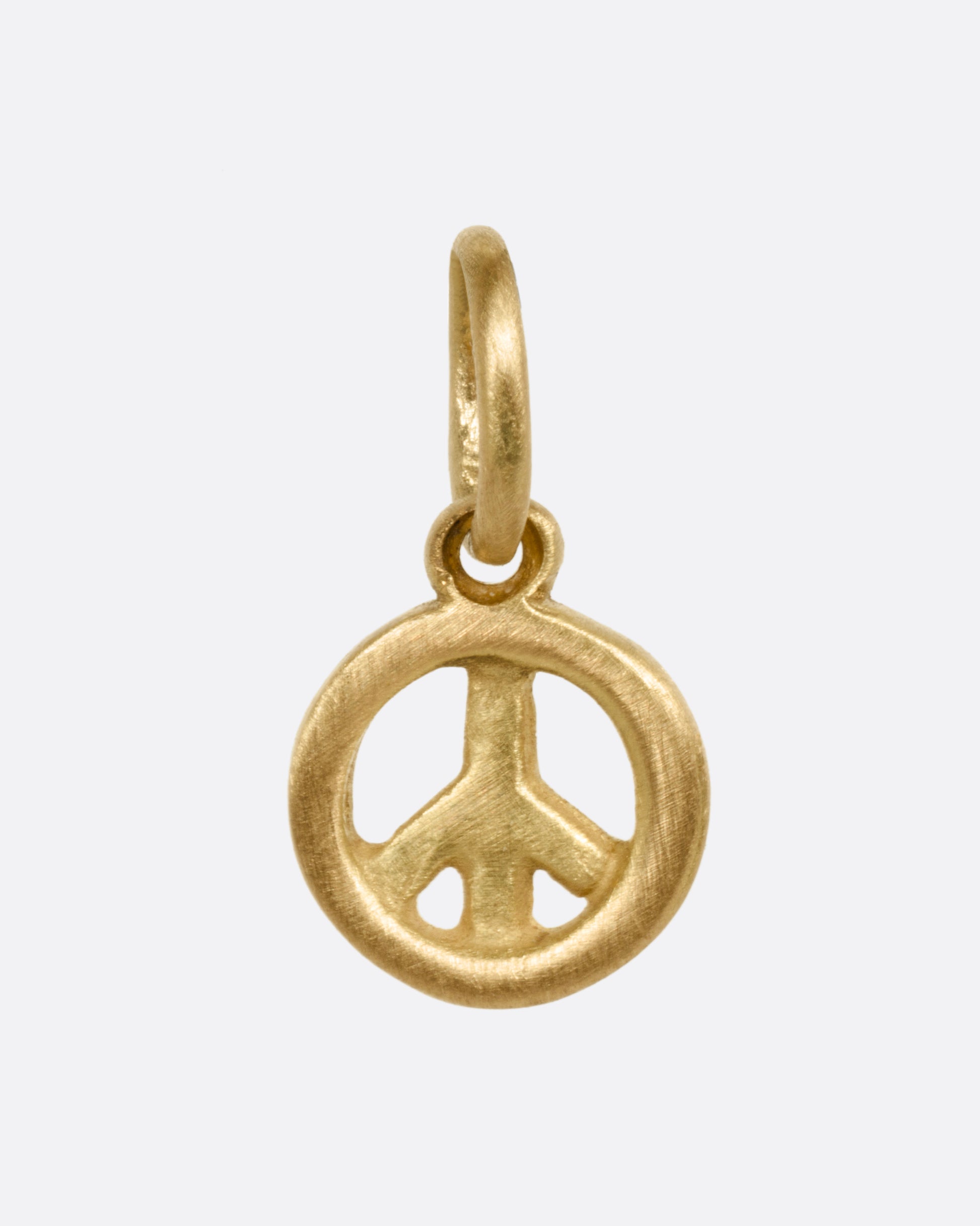 A yellow gold peace sign pendant shown from the front.