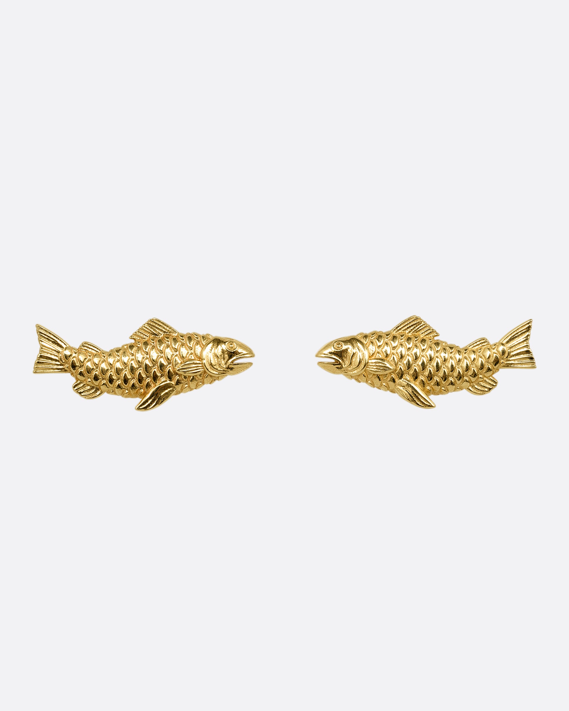 A pair of yellow gold fish earrings. Shown from the front.