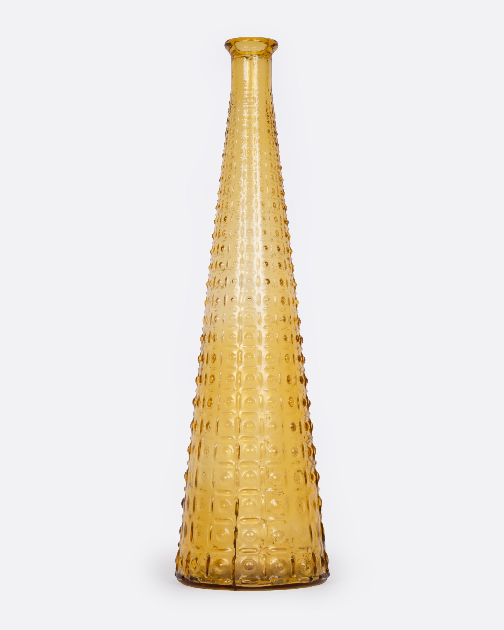 A tall tapered amber glass vase with an Aztec Hobnail exterior, shown from the front.