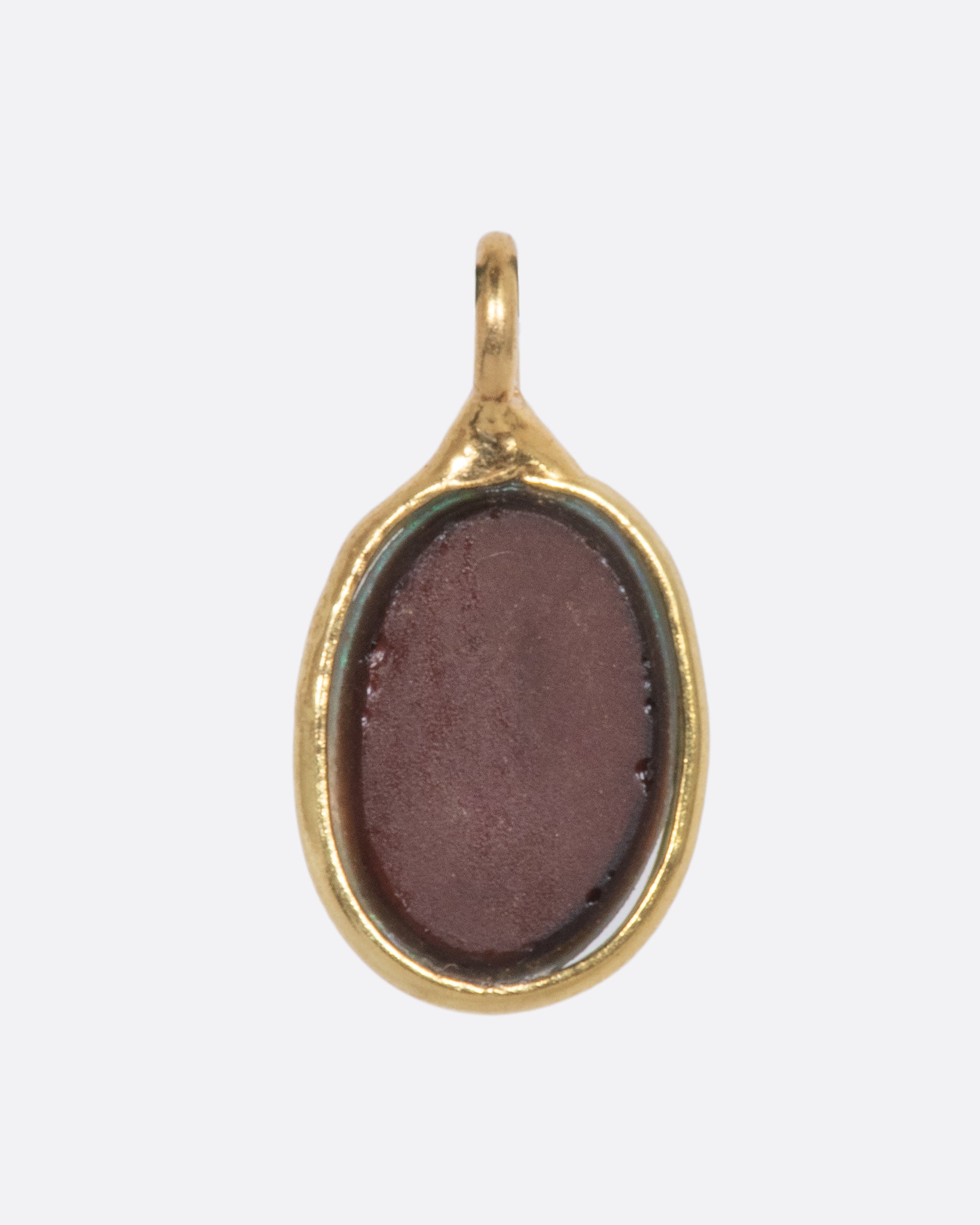 The backside of an Australian opal dangle set in yellow gold. 