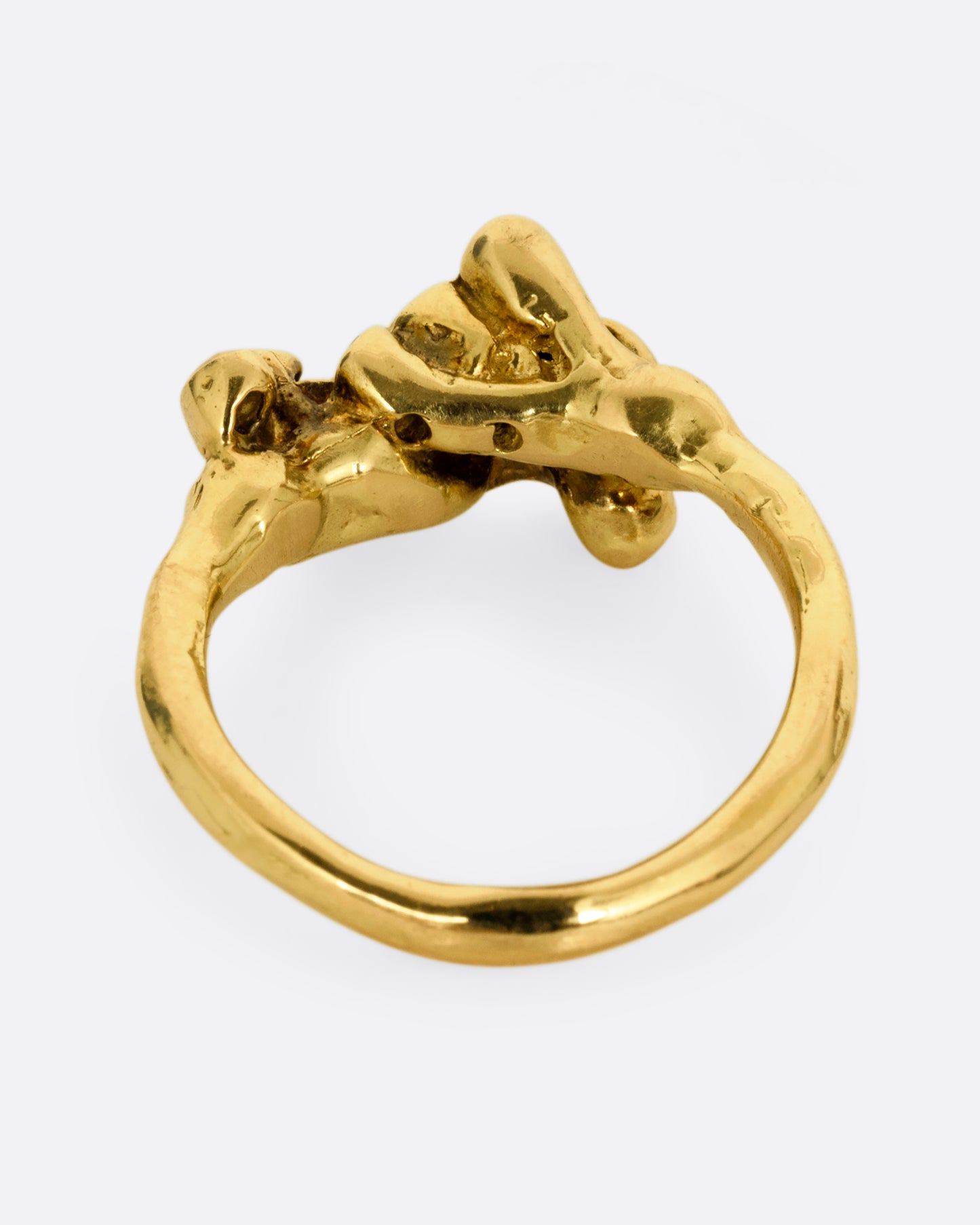 A yellow gold ring with diamond tipped anemones. Shown from the back.