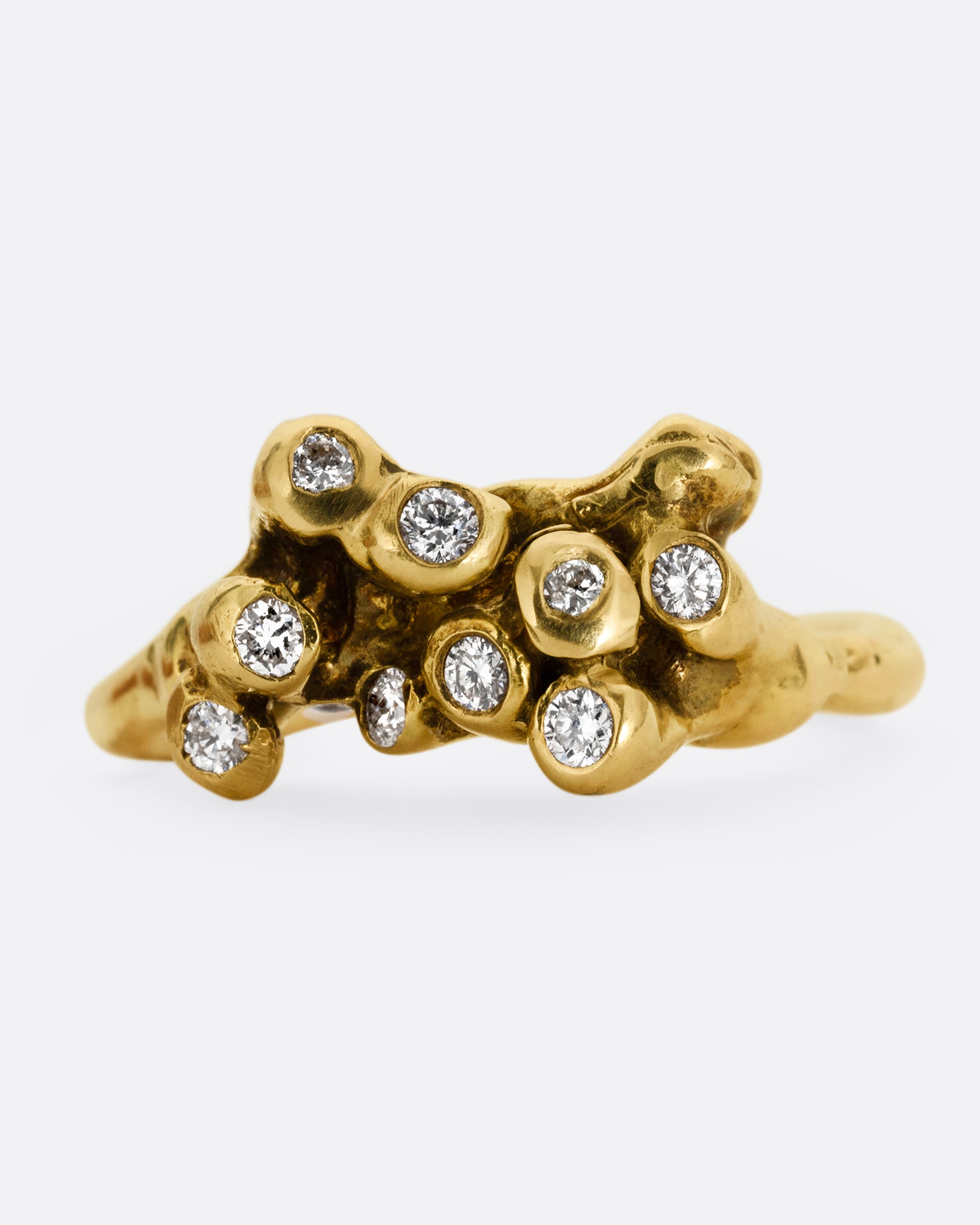 A yellow gold ring with diamond tipped anemones. Shown from the front.