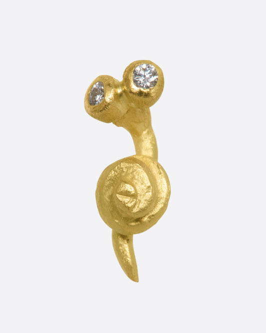 A yellow gold snail earrig with diamond eyes. View from the front.