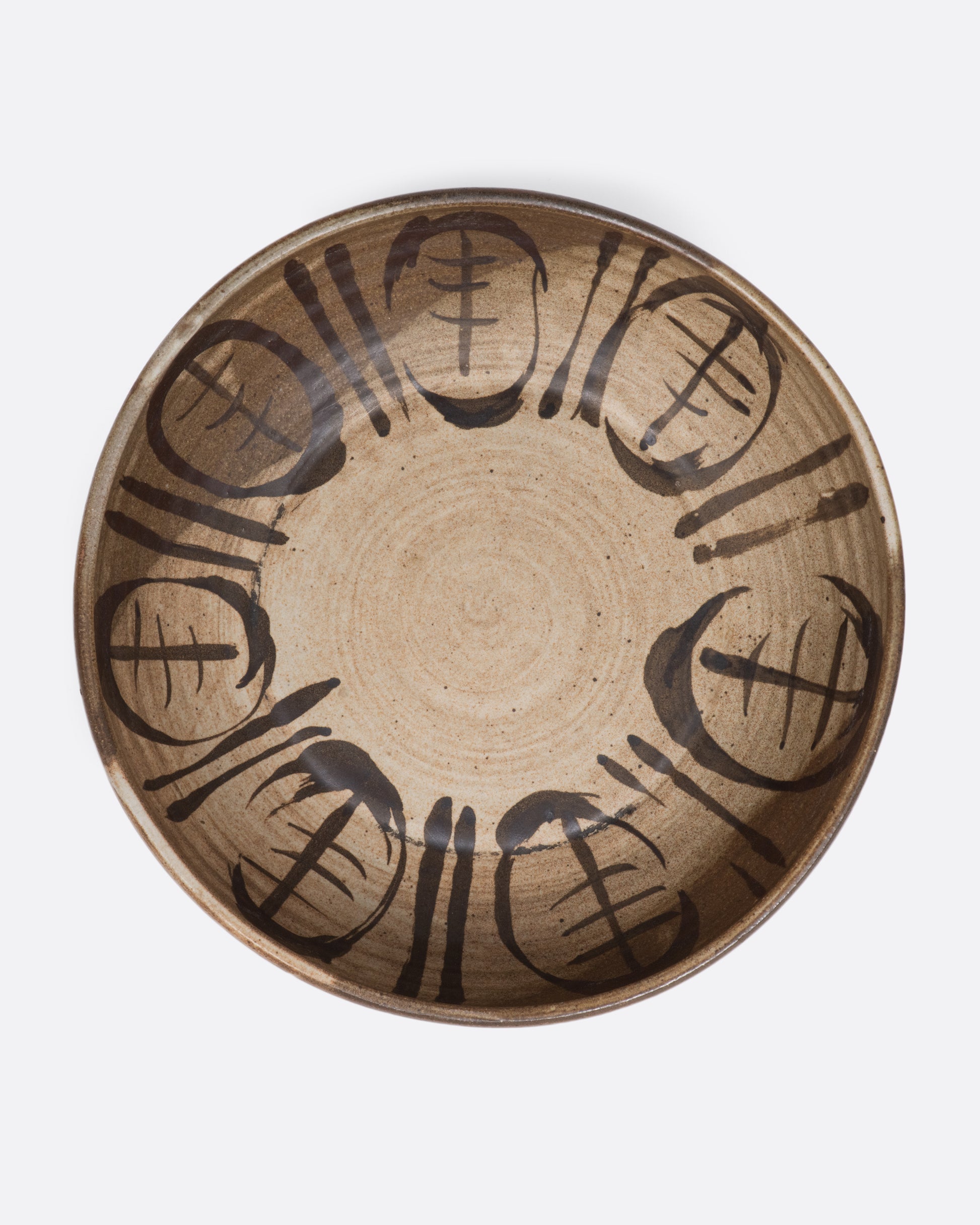 A ceramic deep bowl platter with painted abstract design on the interior. View of interior.