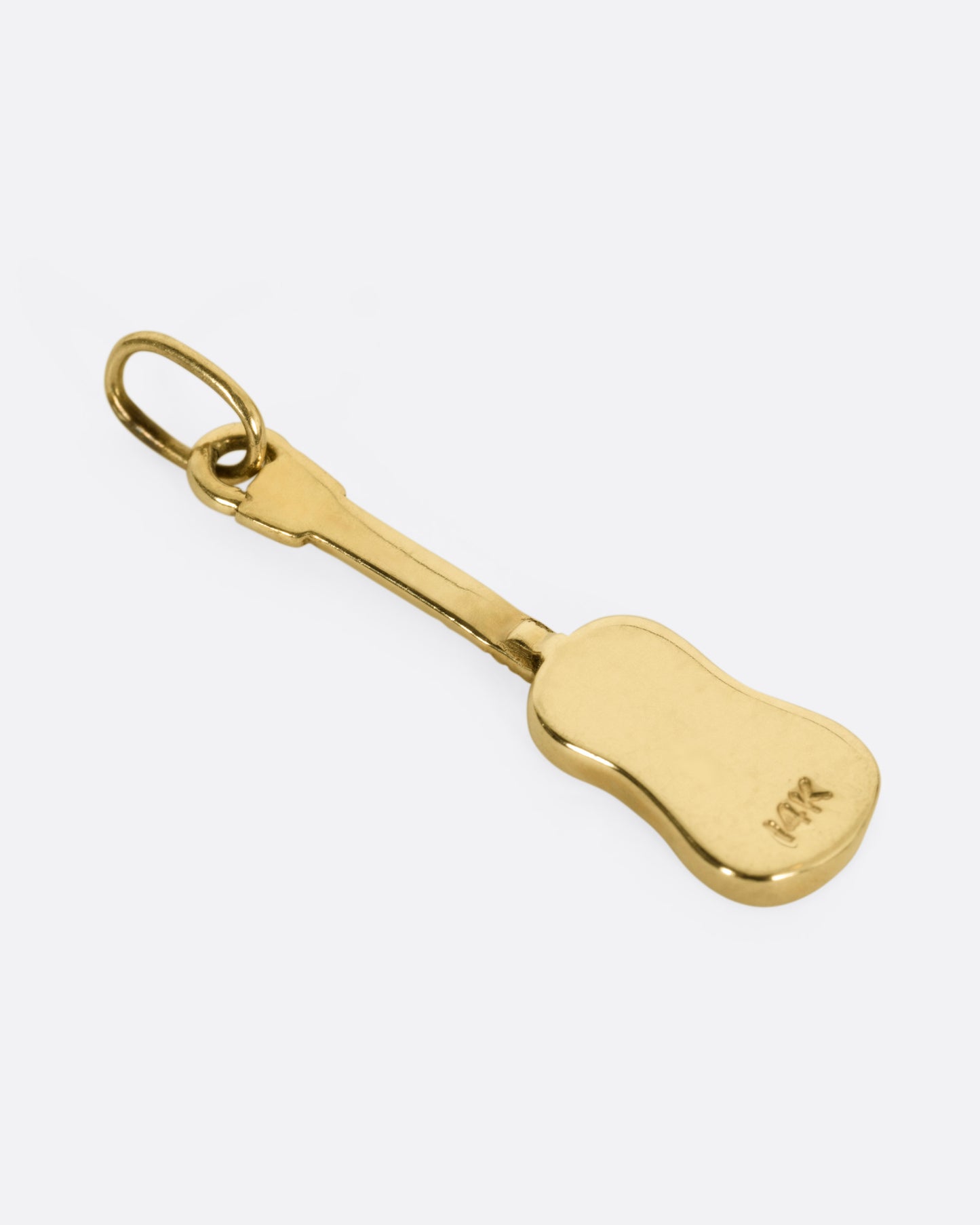 A yellow gold guitar charm, shown from the back.