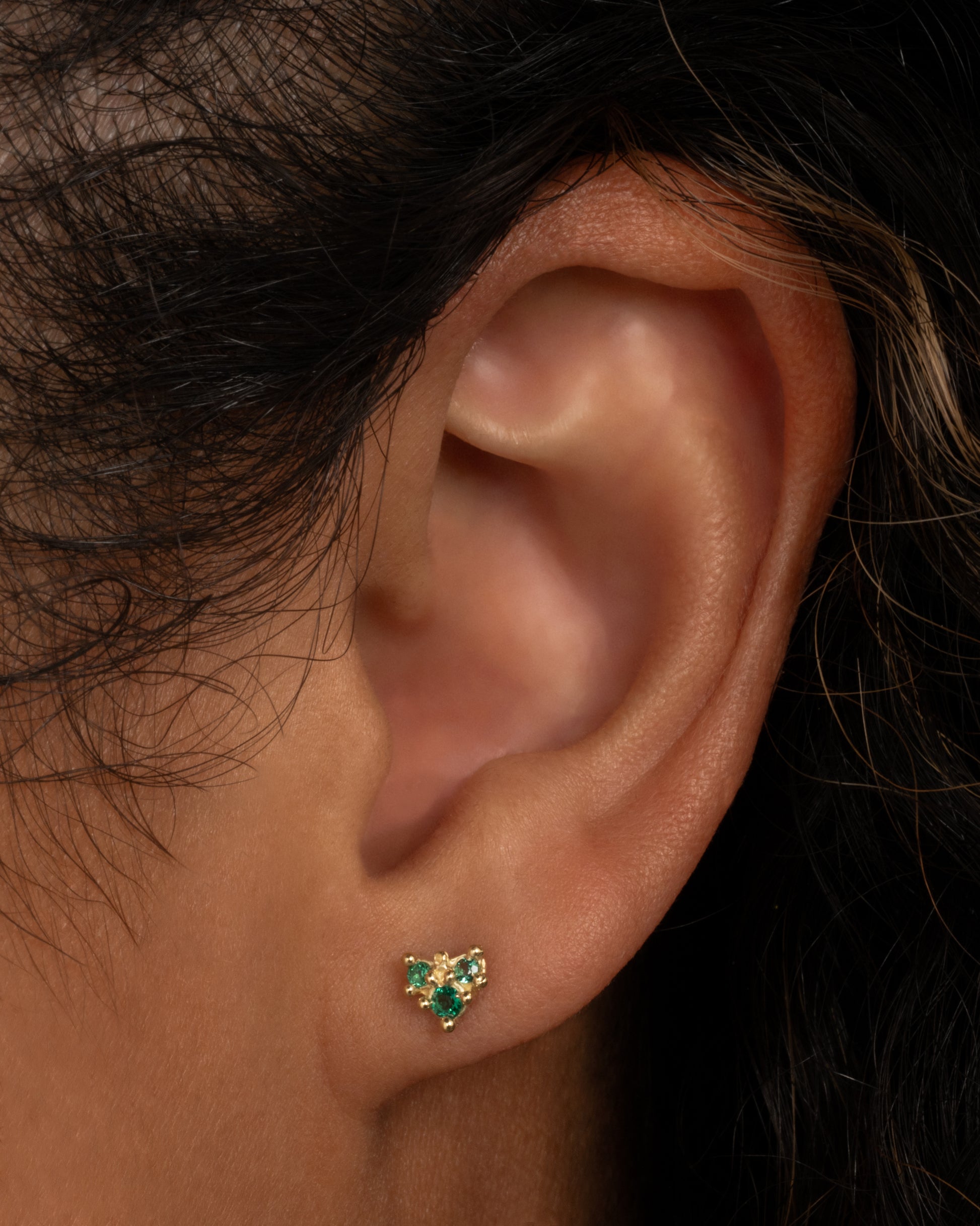 The stones on this arrow earring glow; a perfect pop of color.