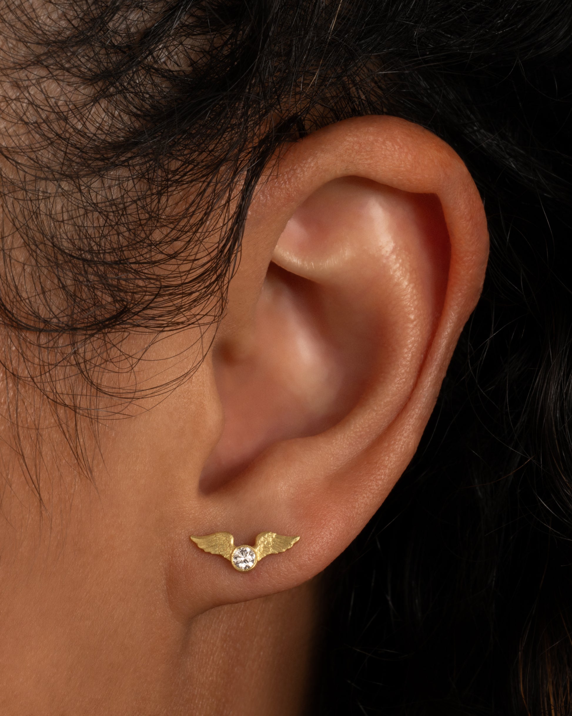 This little stud is inspired by the winged mountings and pavé wing pieces of late Victorian jewelry. Shown worn in an ear.