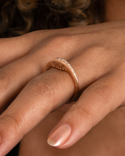 Yellow gold diamond crescent moon ring worn on a finger