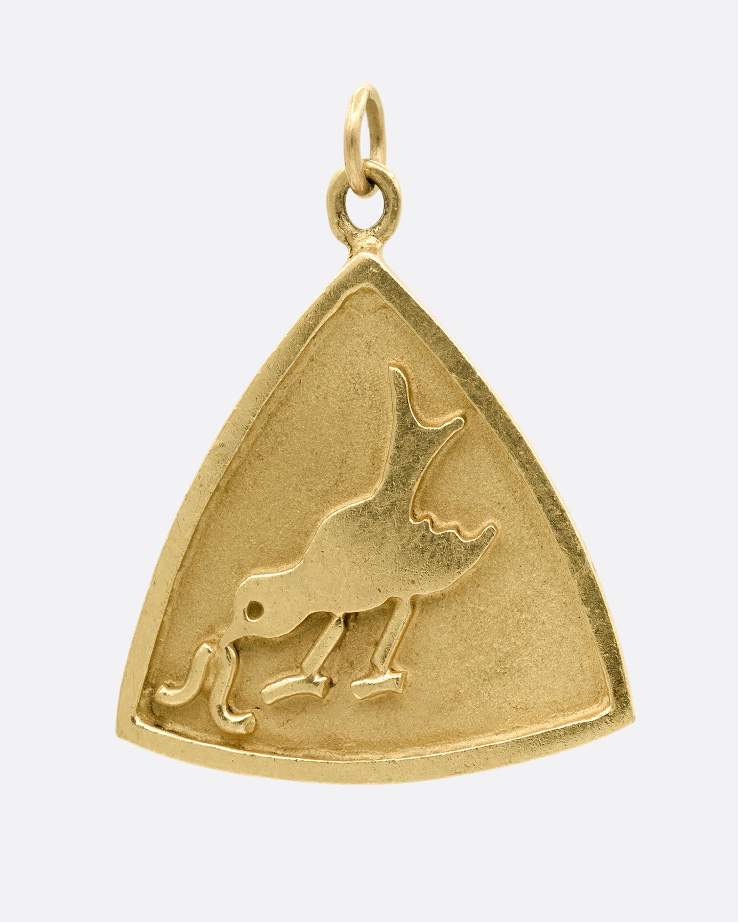 A yellow gold triangular charm with a bird getting worm on the front. Shown from the front.