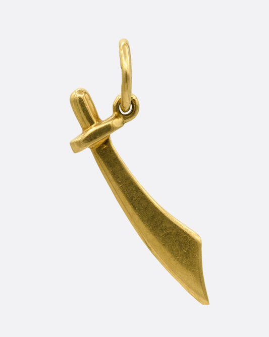 A yellow gold saber pendant. Shown from the front.