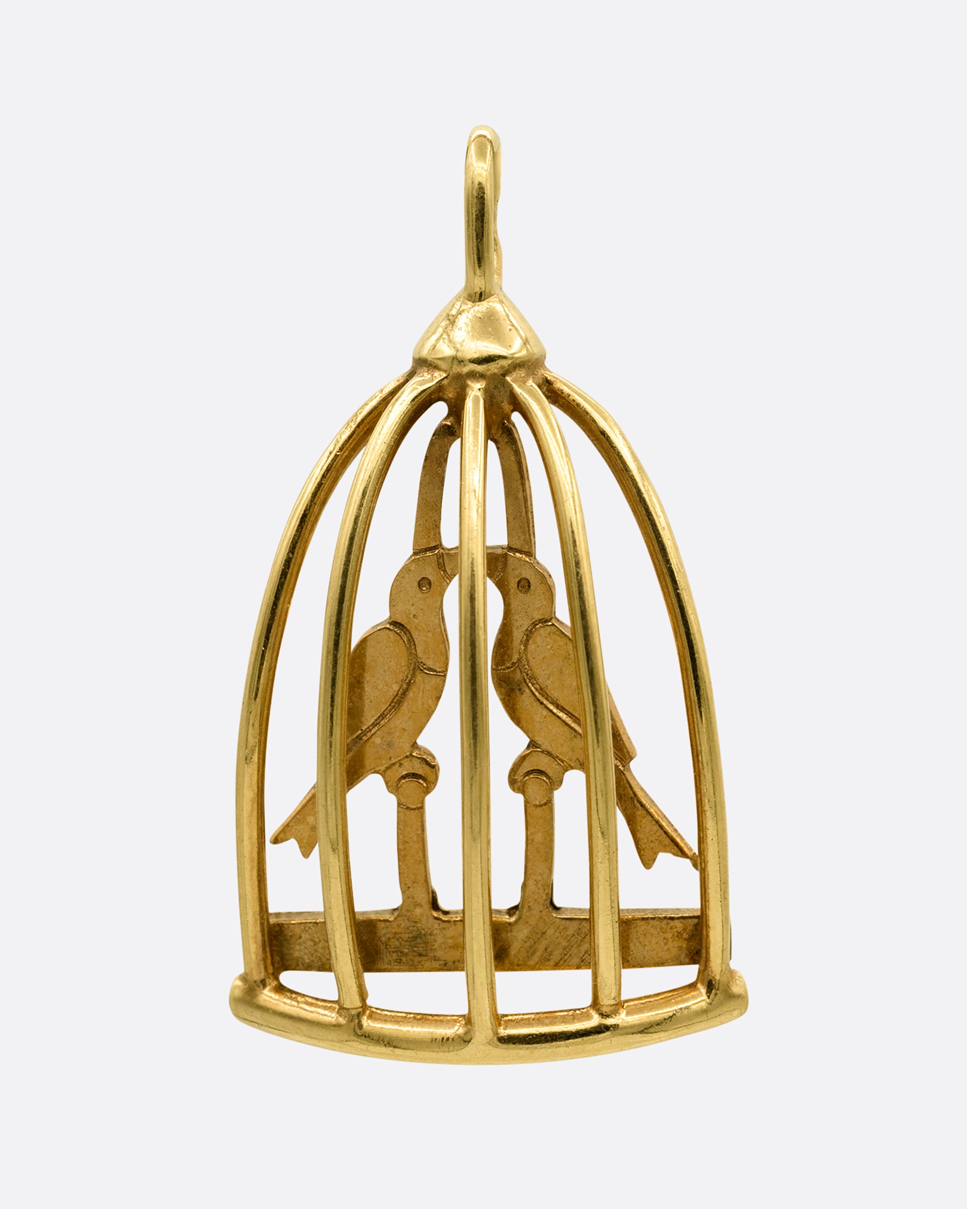 A yellow gold birdcage charm with two lovebirds in it. Shown from the front.