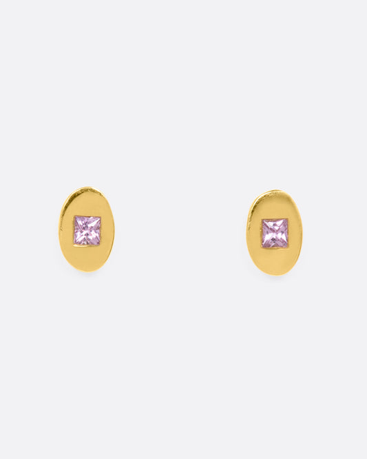 Yellow gold oval studs with princess cut pink sapphires. View from the front.