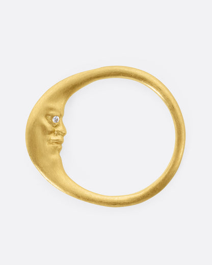Yellow gold diamond crescent moon ring, top view of the ring as a crescent moon, the carved face in profile with a diamond eye