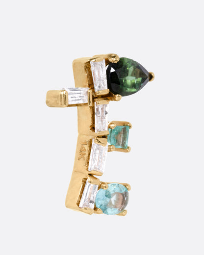 A yellow gold stud earring with a stack  of tourmaline, emerald, sapphire, and diamonds. Shown from the side.