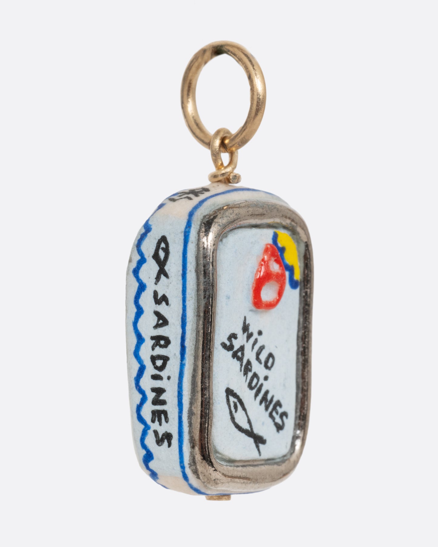 A porcelain hand painted sardine can charm. Shown from the side.