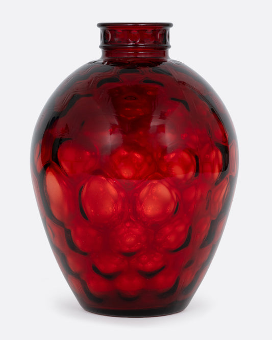 A red glass vase with a smooth exterior and honeycomb texture interior. Shown from the front.