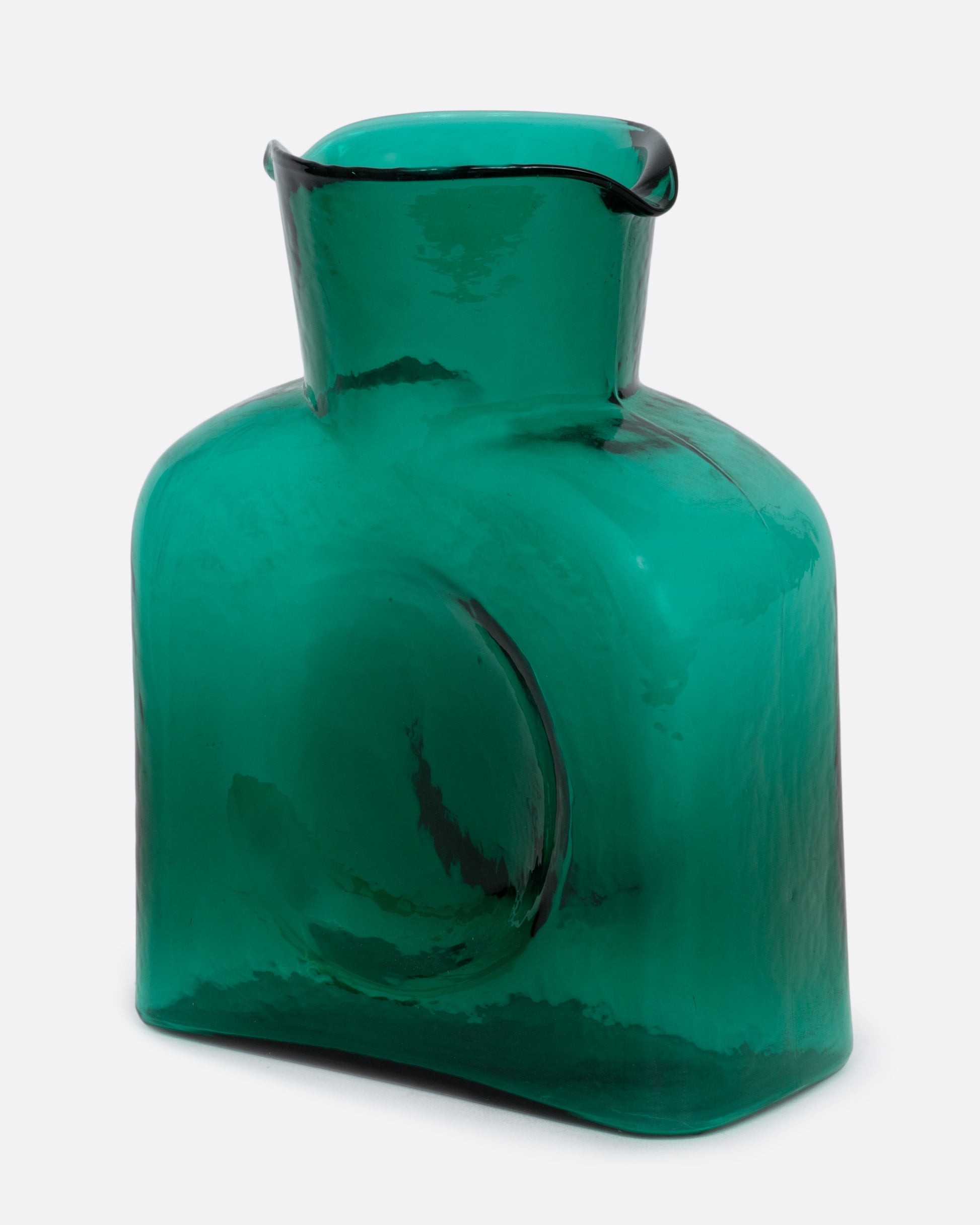A green glass double spouted 'water bottle' from Blenko. Shown at an angle from the front.