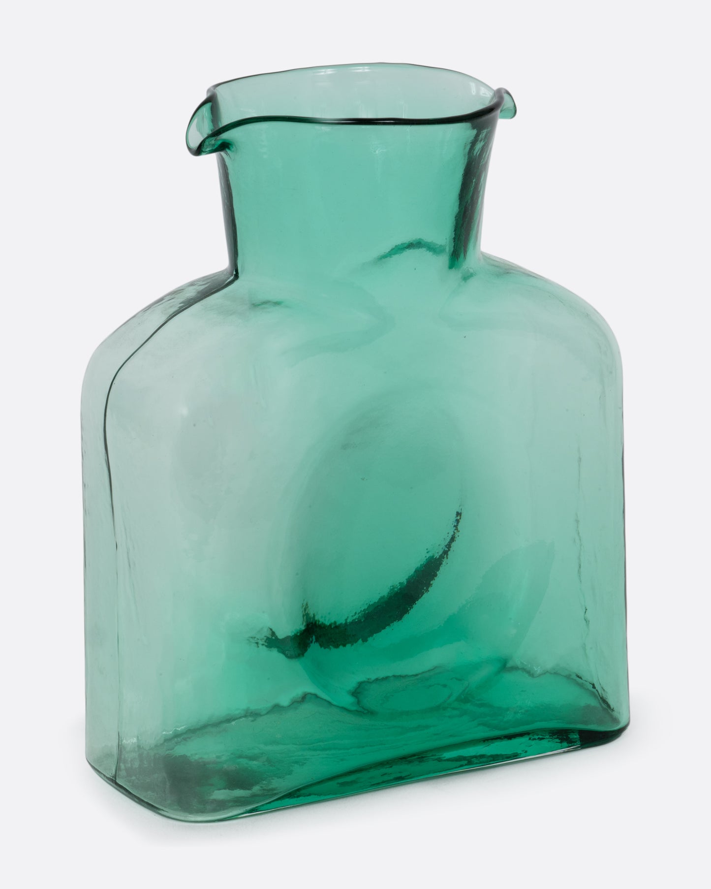 A green gradient glass double spouted 'water bottle' from Blenko. Shown at an angle from the front.