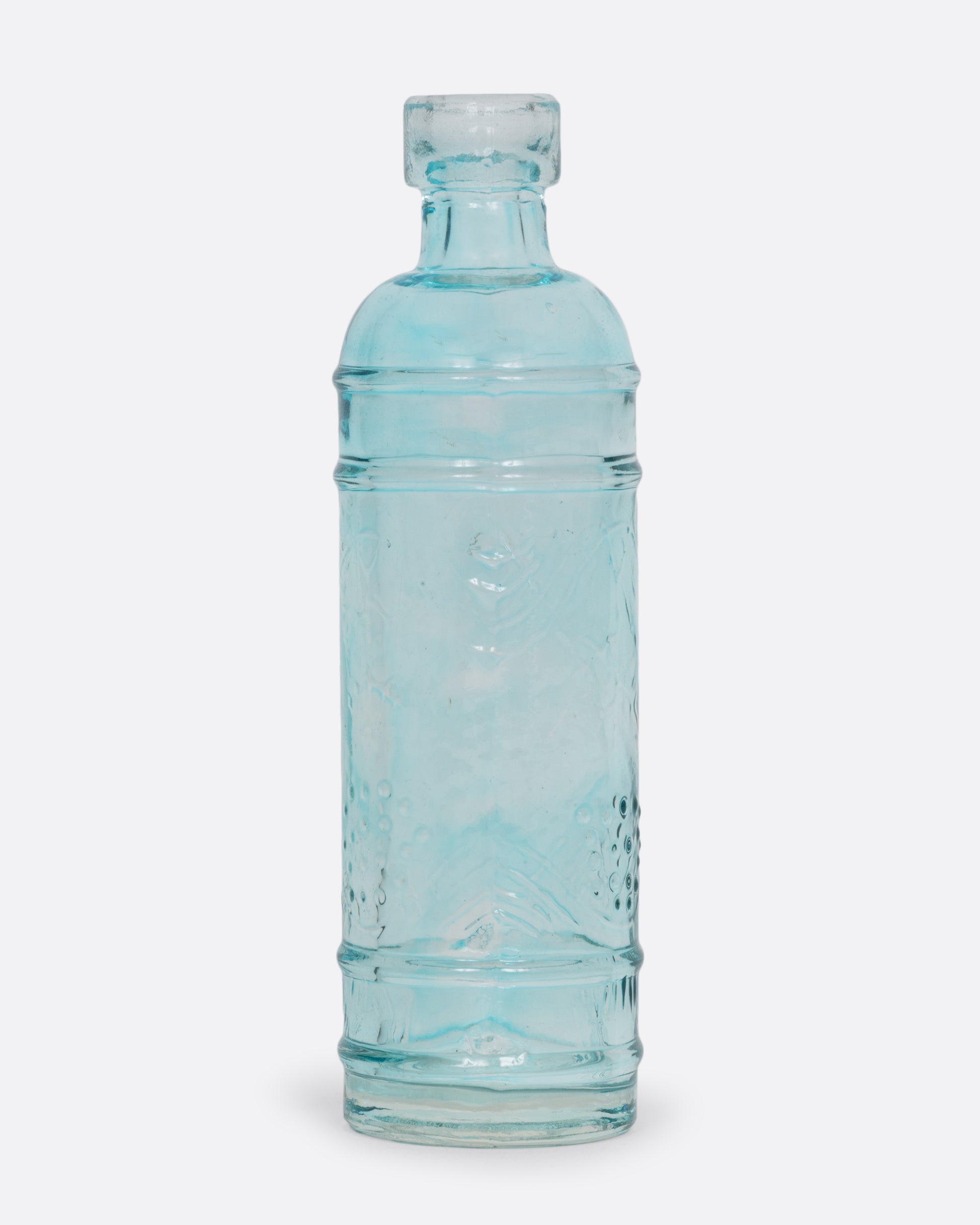 A tiny clear aqua glass bud vase shown from the front.