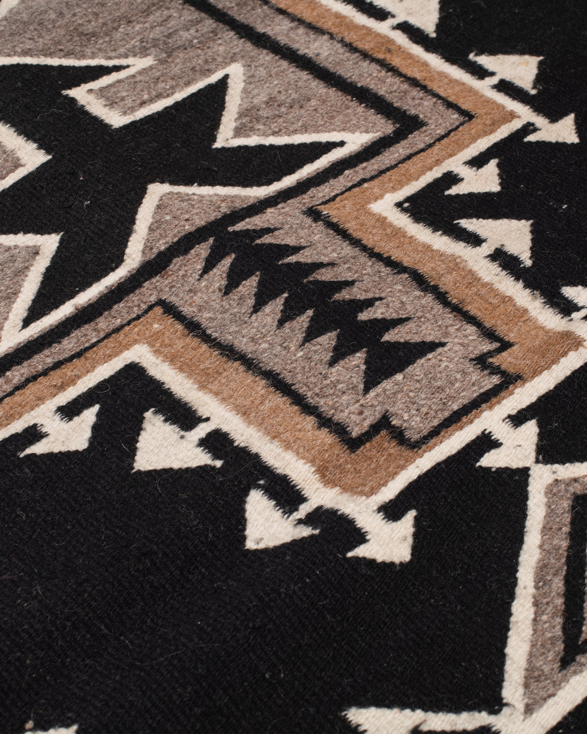 A vintage Navajo rug with the traditional Two Grey Hills weaving