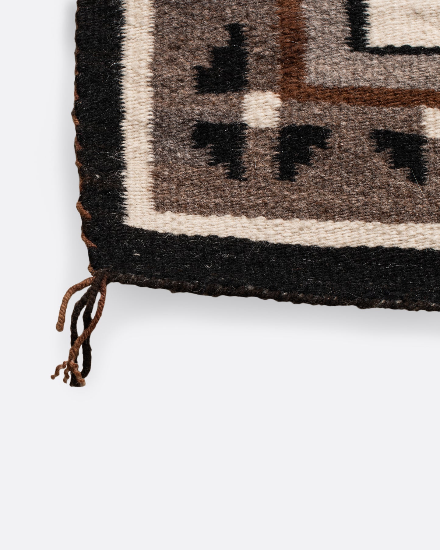 A vintage Navajo square rug with the traditional Two Grey Hills weaving