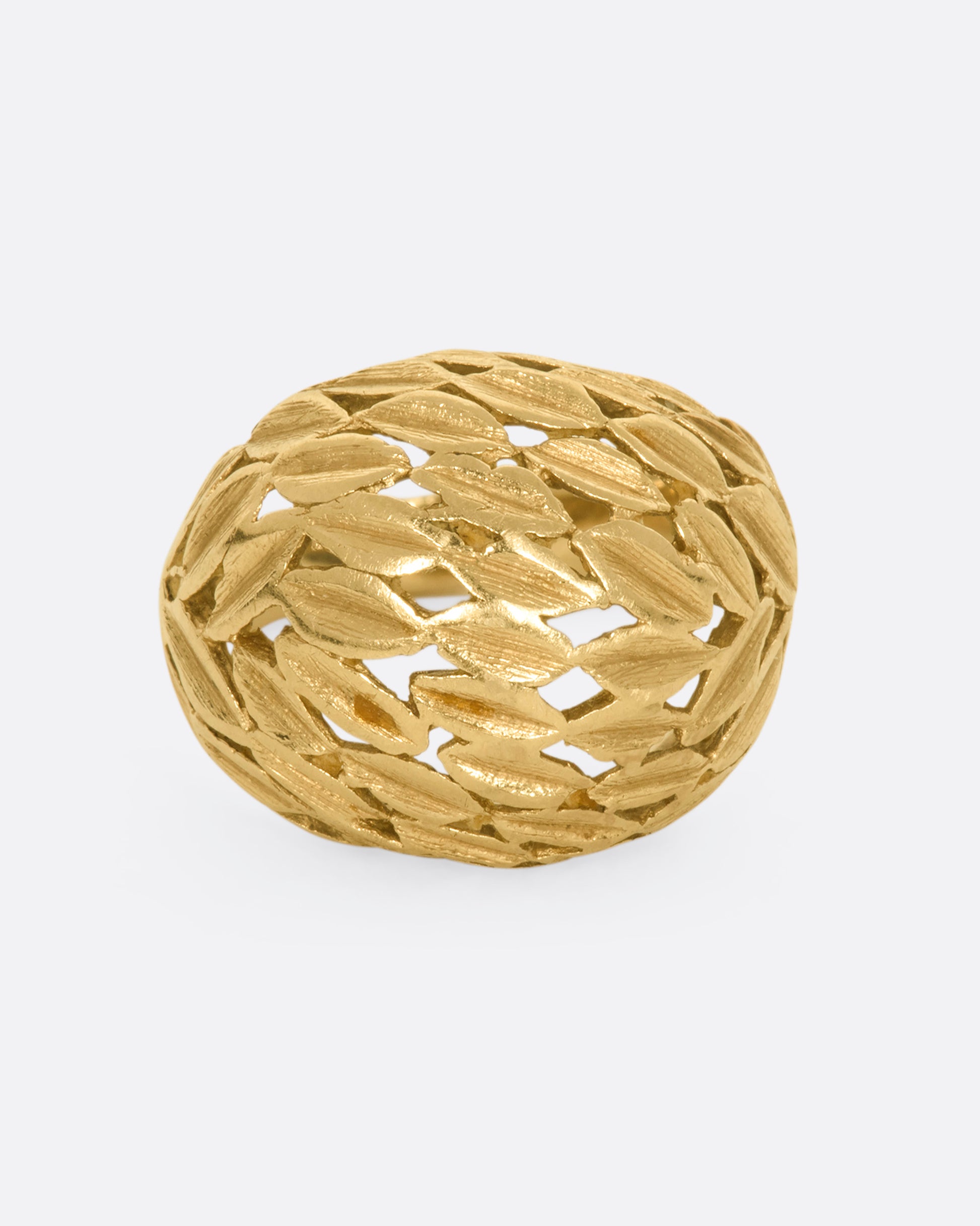 A yellow gold dome shaped ring with a leaf motif. View from the front.