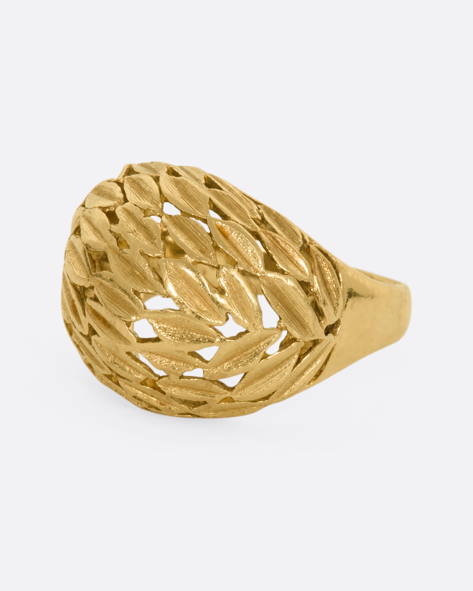 A yellow gold dome shaped ring with a leaf motif. View from the alternate side.