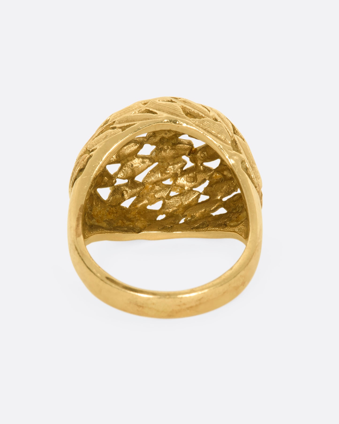 A yellow gold dome shaped ring with a leaf motif. View from the back.