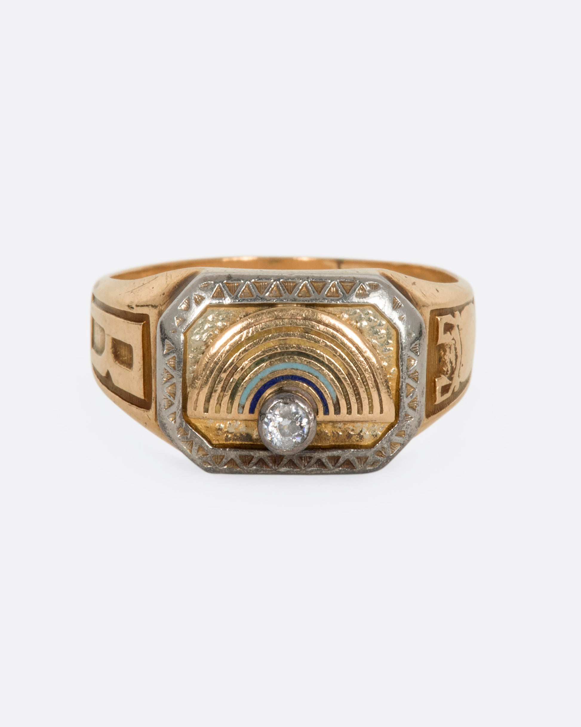 A yellow gold vintage signet ring with an arch and a round diamond on the front. View from the front.