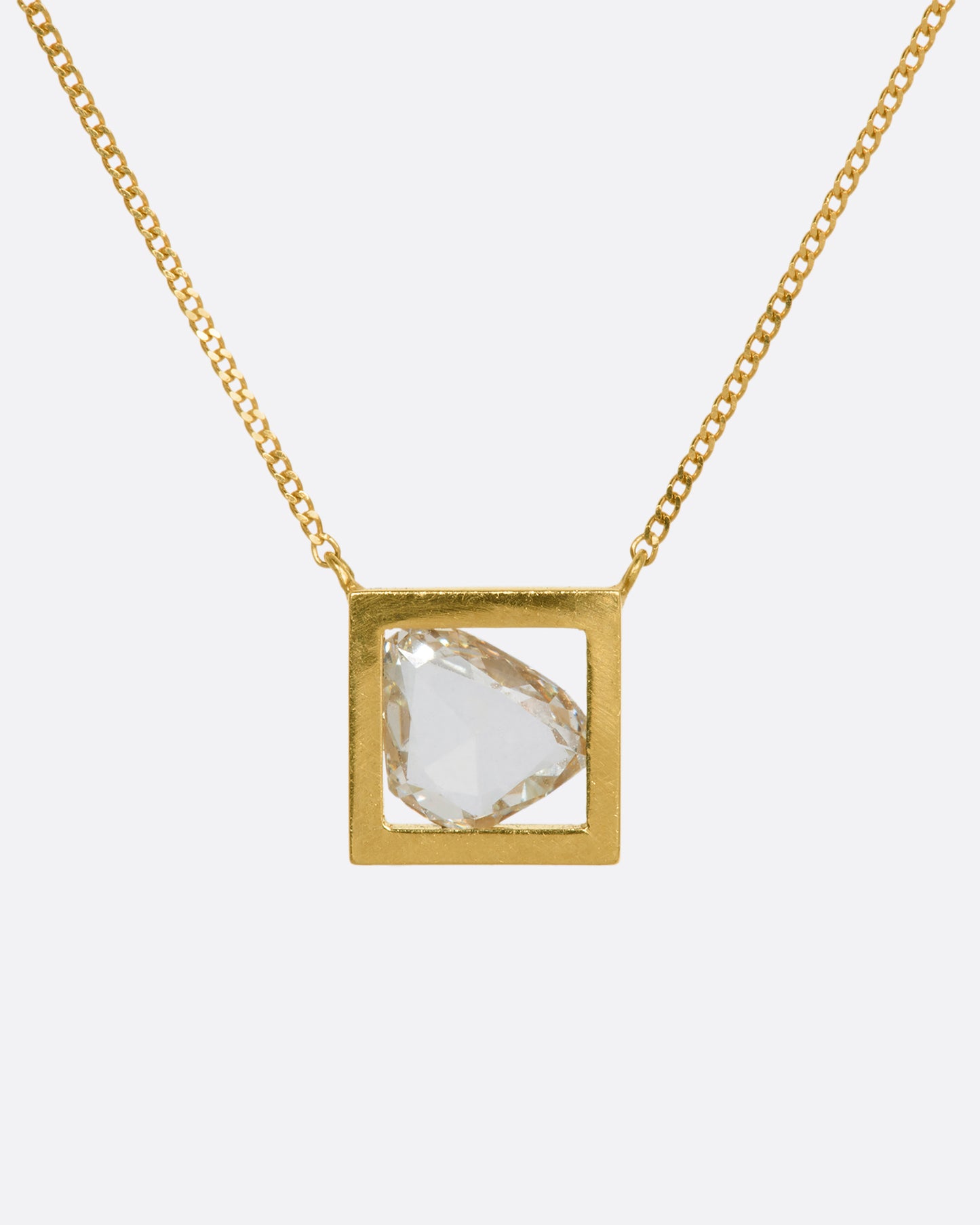 A yellow gold square fixed pendant frame holds a rose cut diamond slice hanging from a chain. View from the front.