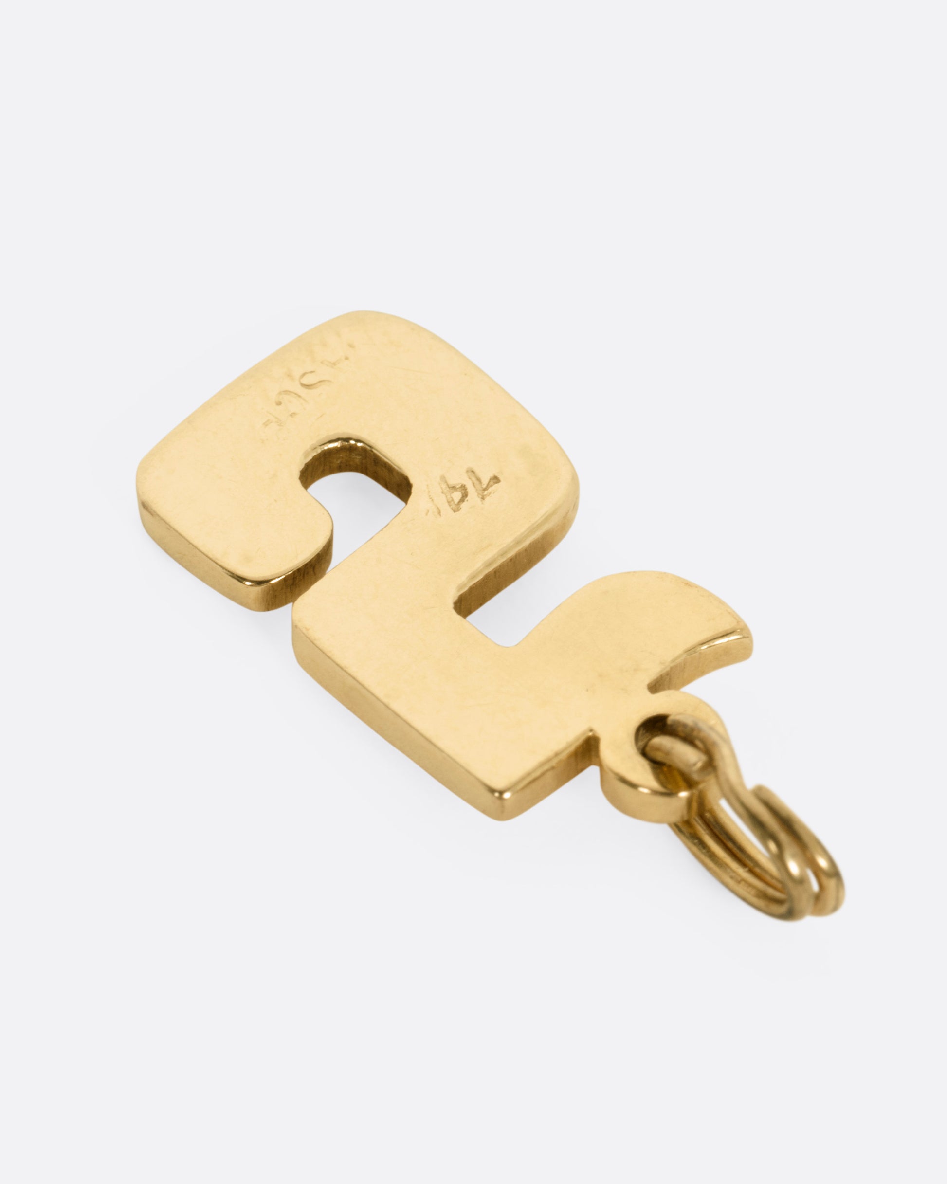 A yellow gold 5 charm, shown from the back.