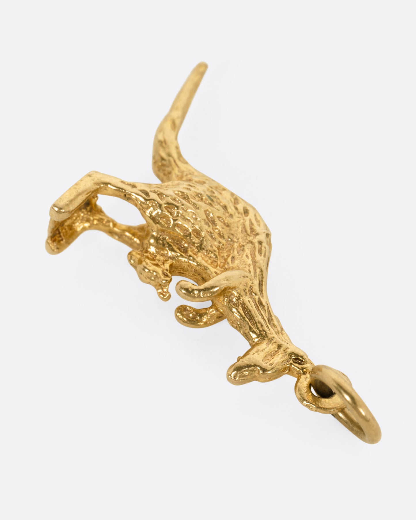 A yellow gold kangaroo and baby joey pendant, shown from the back.